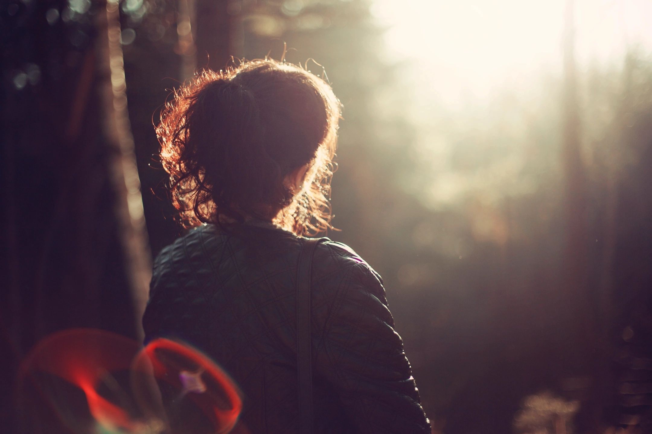 woman sits in chair looking at afternoon sun